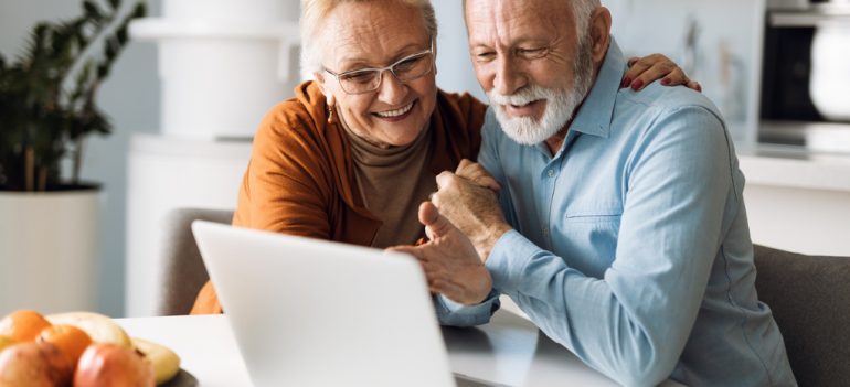 An older couple using a laptop.